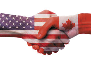 United States and Canada bilateral political relations and cooperation concept with USA and Canadian flags painted on handshake 