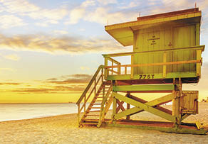 Miami South Beach sunrise with lifeguard tower and coastline with colorful cloud and blue sky  