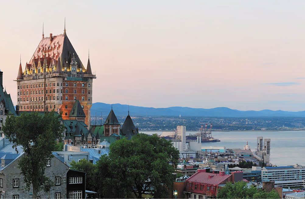 Quebec City skyline panorama with Chateau Frontenac at sunset viewed from hill