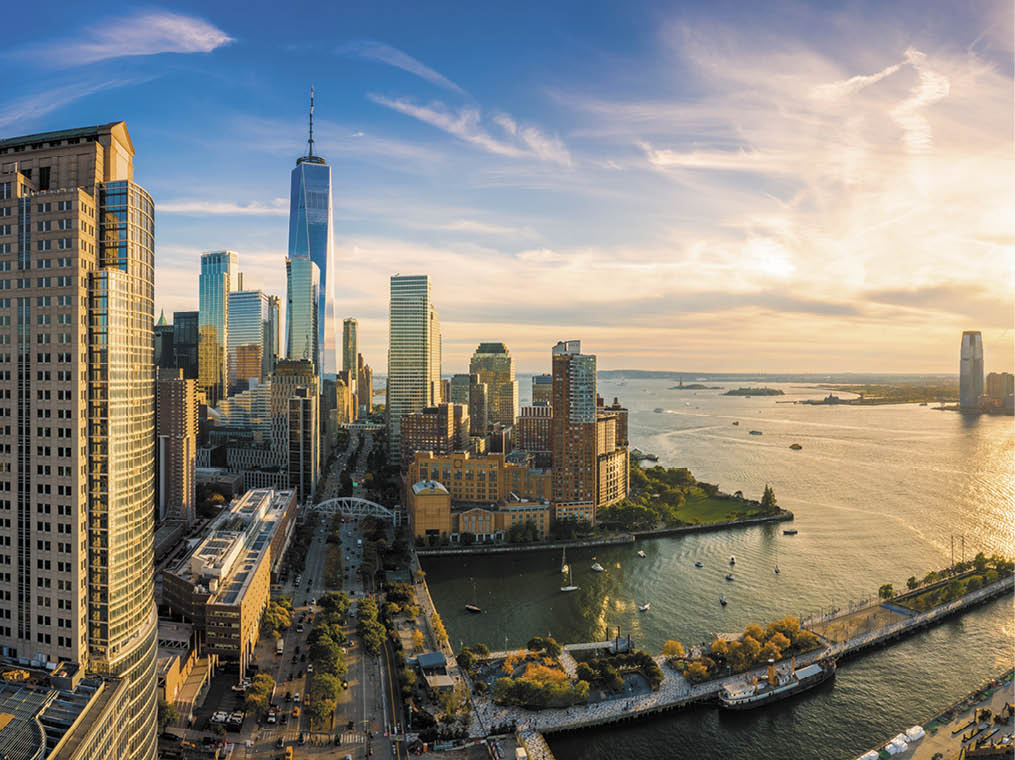 Aerial view of Lower Manhattan skyline at sunset viewed from above West Street in Tribeca neighborhood 