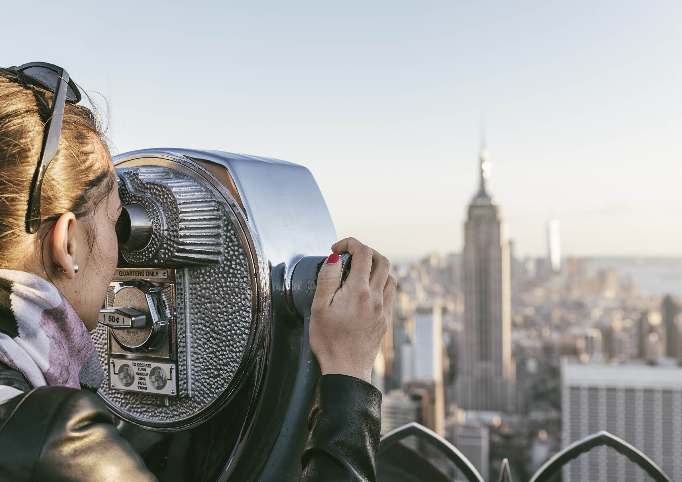 Tourist woman using binoculars in rooftop  New York Concept 